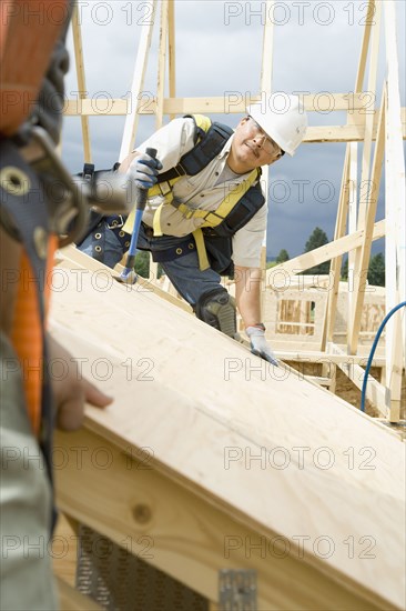 Construction workers building house