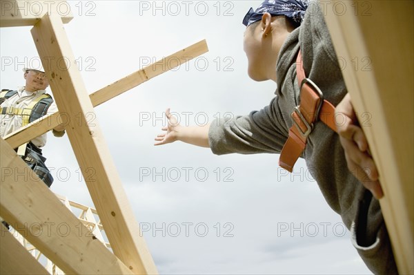 Construction workers building house