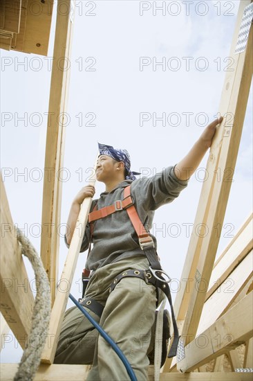 Hispanic construction worker building house