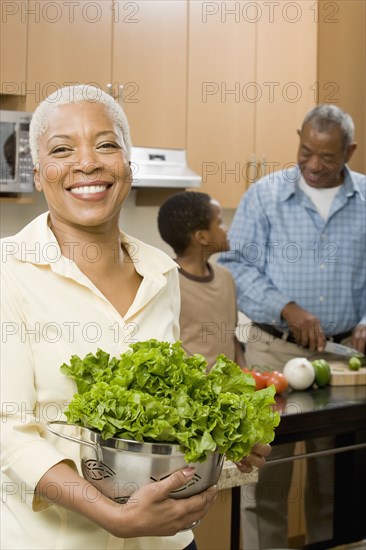 African woman preparing salad