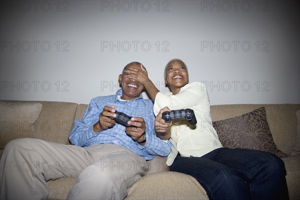 African couple playing video game