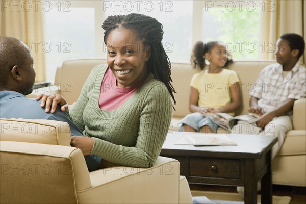 African American family sitting in living room