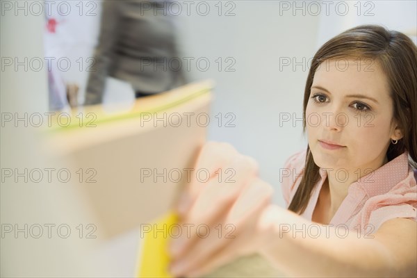 Caucasian businesswoman holding folder