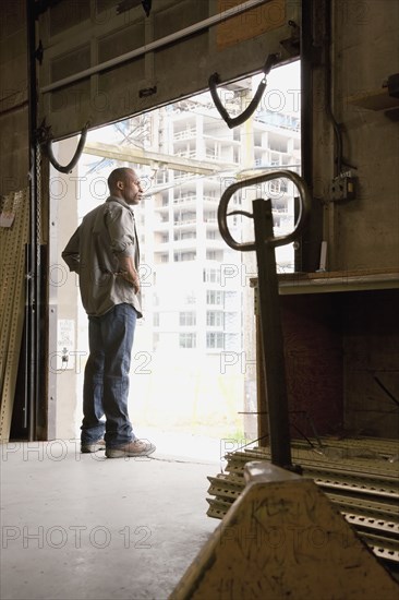 Black man standing on warehouse loading dock