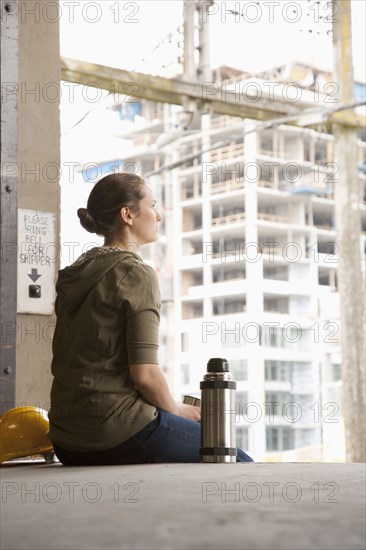 Mixed race woman taking a break on warehouse loading dock