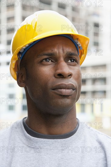 Black construction worker frowning