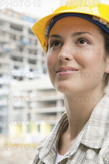 Mixed race woman in hard-hat on construction site