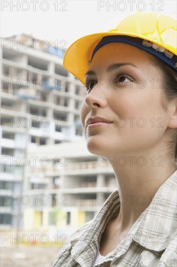 Mixed race woman in hard-hat on construction site