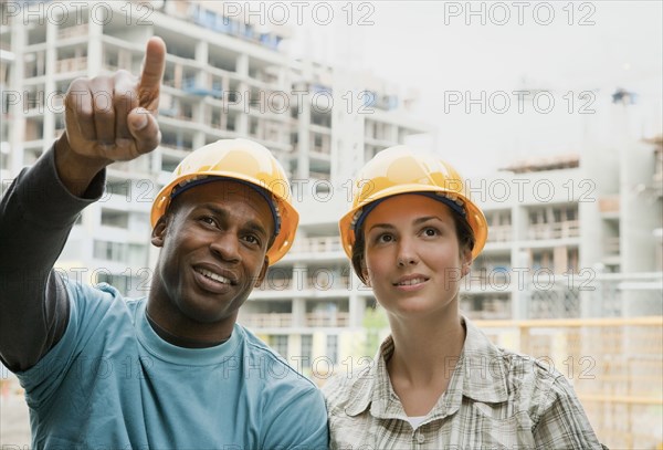 Man and woman in hard-hats on construction site