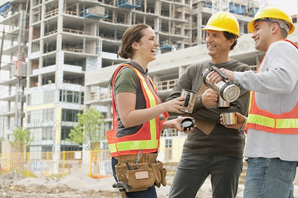 Construction workers on construction site drinking coffee