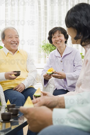 Chinese family enjoying fruit and tea
