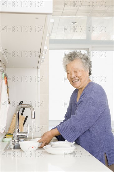 Chinese woman washing dishes
