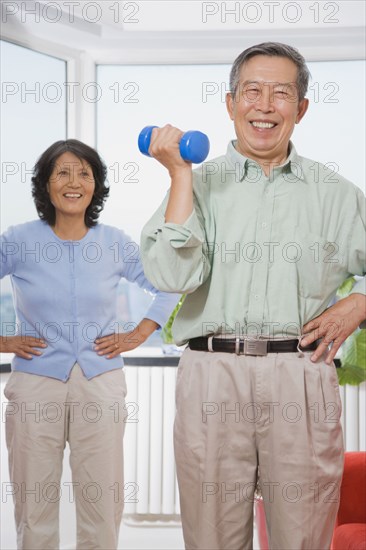 Chinese man lifting hand weight