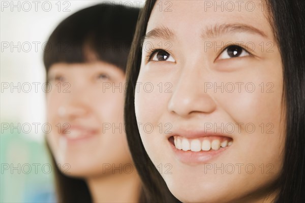 Chinese women smiling and looking up