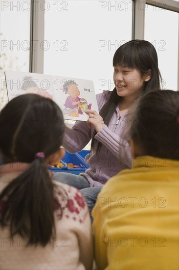 Chinese woman reading to children