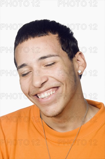 Mixed race teenage boy smiling with eyes closed