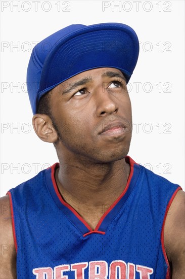 Hispanic man in baseball cap looking up