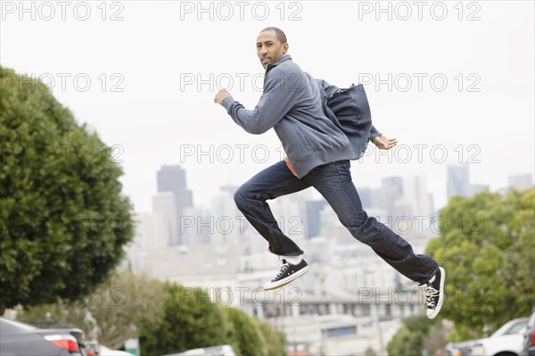 African American man running on urban street