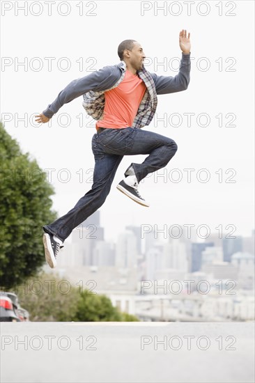 African American man running on urban street