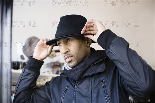 African American man adjusting fedora