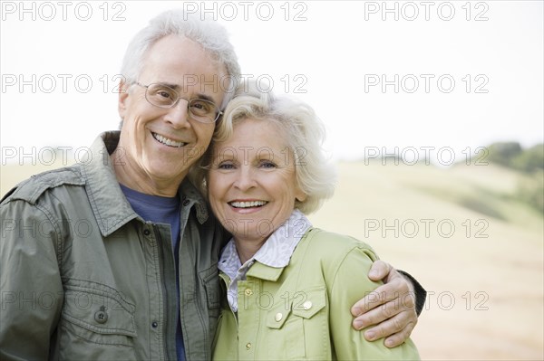 Caucasian couple hugging outdoors