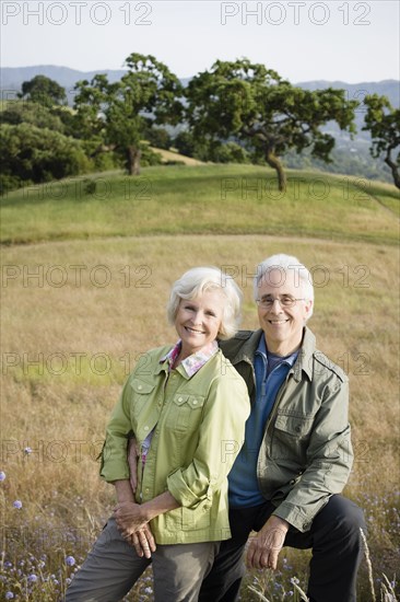 Caucasian couple standing in field