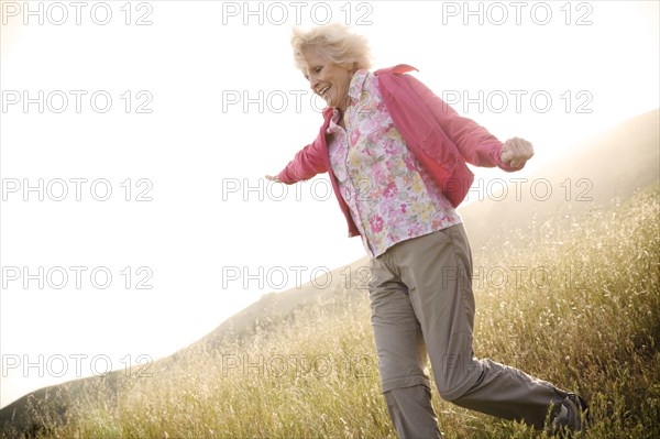 Caucasian woman running down hill