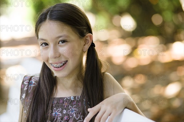 Smiling mixed race girl with braces