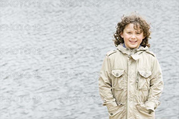 Smiling Caucasian boy with hands in pockets