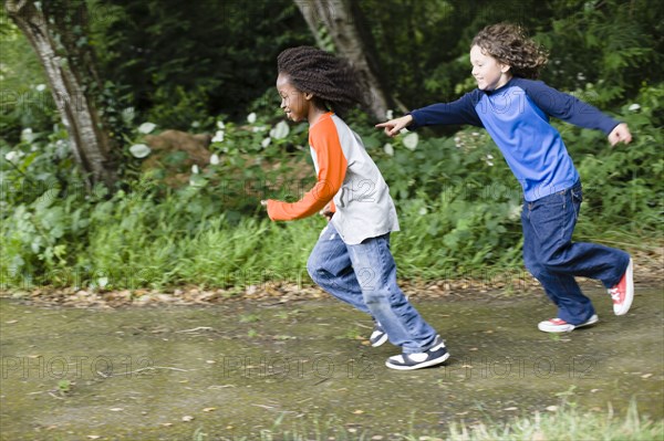 Boys playing tag in the park