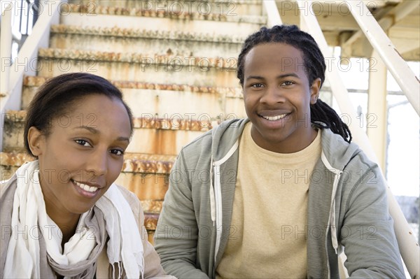 Black couple sitting on staircase