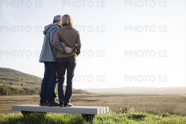 Caucasian couple hugging on beach