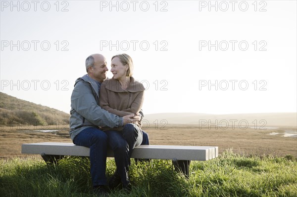 Caucasian couple hugging on beach