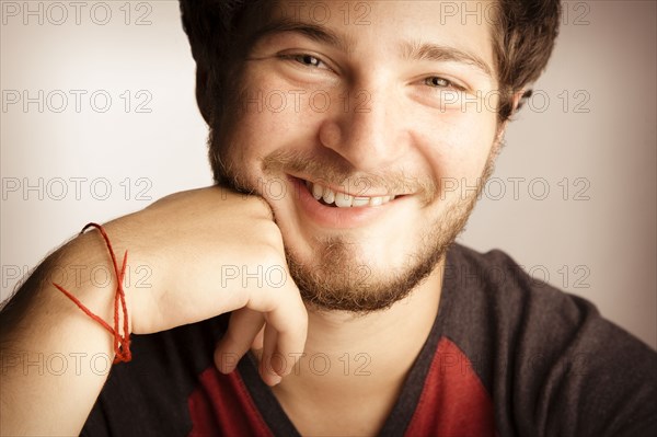 Smiling man with hand on chin