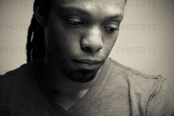 Serious African American man looking down