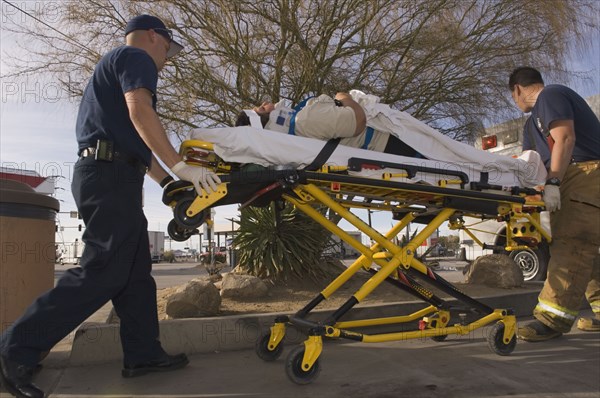 EMT workers with accident victim on gurney