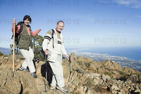 Senior couple hiking on cliffs