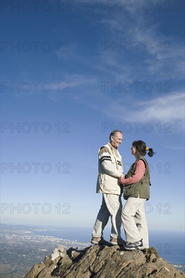Senior couple on top of cliff