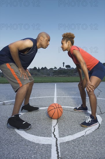 African man and woman on basketball court