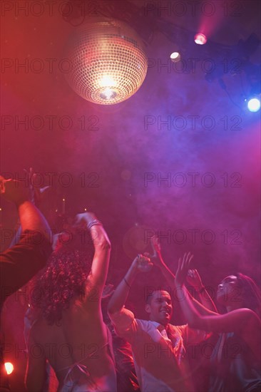 Multi-ethnic people dancing at nightclub