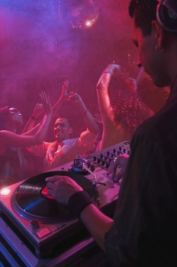 Hispanic dj playing at nightclub