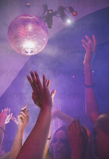 Multi-ethnic people dancing at nightclub
