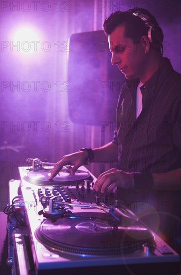 Hispanic dj playing at nightclub