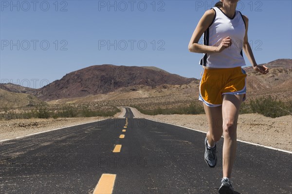 Mixed Race female runner on road