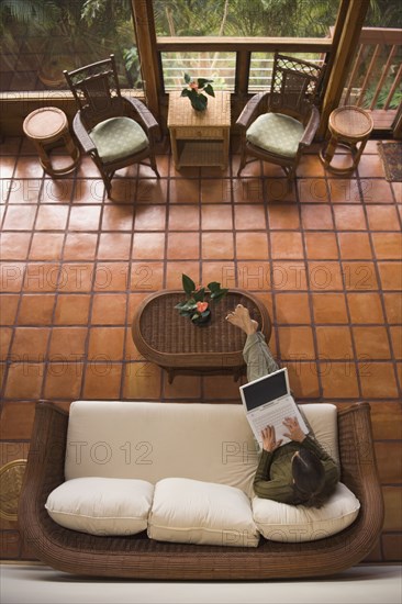 High angle view of woman using laptop on sofa