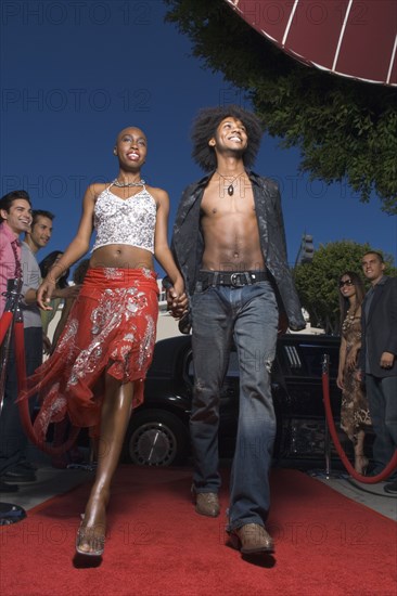 African couple walking on red carpet