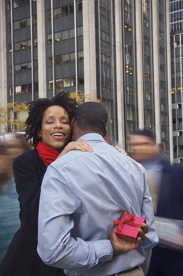 African American man surprising wife with gift