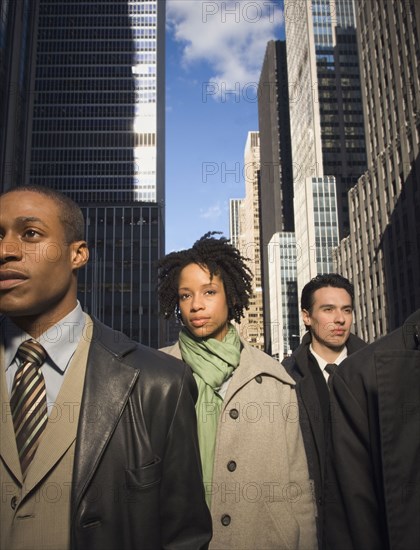 Multi-ethnic businesspeople in urban scene