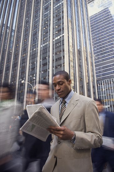 African American businessman reading newspaper