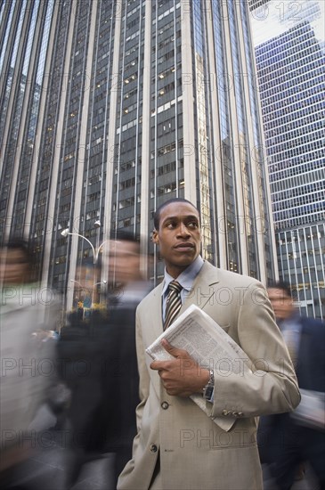 African American businessman holding newspaper